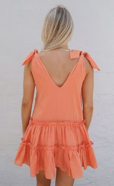 This sorbet colored mini dress is adorable and such a fun pop of color for your summer wardrobe. We love the v-neckline, tie straps and ruffle tiered skirt. It's the perfect mini dress to style casually with sandals or sneakers or dress up with heels. Katie is 5'5" and is wearing size extra small extra small measurements: 36" bust | 31" length + tie straps 100% cotton WE ONLY OFFER STORE CREDIT FOR RETURNS! Feel free to email us at orders@shopriffraff.com or DM us with any questions regarding fi Western Tee, Gameday Outfit, Art Dress, Tier Skirt, Tiered Skirt, Summer Wardrobe, Pop Of Color, Jumpsuit Dress, Dresses For Sale