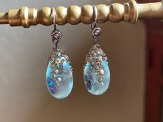 These barnacle Earrings a fit for a mermaid, feminine and elegant. The drops are made with a mix of pale aqua transparent and rainbow dichroic glass which looks like droplets of magic water. Earwire findings are solid sterling silver. There is a companion pendant for these earrings available: https://www.etsy.com/listing/549526469/sparkling-barnacle-capped-flamework-aqua Get both for a matching set! Unique Iridescent Teardrop Earrings, Unique Teardrop Crystal Earrings For Jewelry Making, Magic Water, Pale Aqua, Resin Jewellery, Swarovski Beads, Bird Earrings, Shades Of Beige, Drop Beads