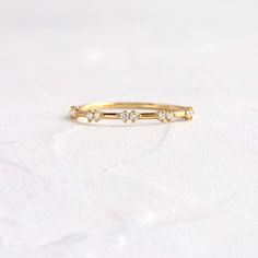 a gold ring with three diamonds on it