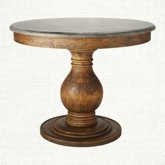 a round wooden table with marble top