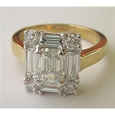 an emerald cut diamond ring set in yellow gold