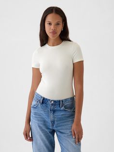 Soft, stretchy cotton-modal blend T-shirt bodysuit.  Crewneck.  Short sleeves.  Snaps at inseam.  Full coverage back.  Fit: Stretch-to-Fit.  Slim & stretchy that forms to your shape.  Models wearing Gap White Fitted Shirt Outfit, Shirt Bodysuit, Body Suit Outfits, Body Suit, Family Pictures, Shirt Outfit, White Shirt, Workout Shirts, Gap