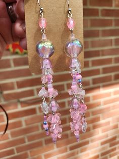 Named after the Pink Meanie jellyfish species, these pretty pink earrings will probably make your sea-loving friends pretty jelly! These earrings come with a heap of acrylic beads, some glass beads, and a few small pieces of rose quartz! They also have quite the lovely jingle to them when they're swinging to and fro. Length of earring is about 5 inches and weight per earring is about 0.275 oz* *measurements of drop length and weight are imprecise and should not be taken as a strict guarantee Whimsical Pink Beaded Earrings, Cute Pink Dangle Beaded Earrings, Cute Pink Beaded Dangle Earrings, Whimsical Pink Dangle Earrings, Whimsical Pink Resin Jewelry, Pink Beaded Crystal Drop Earrings, Pink Beaded Drop Crystal Earrings, Pink Beaded Resin Jewelry, Handmade Pink Crystal Dangle Earrings