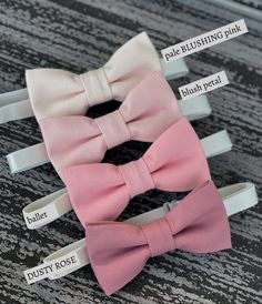 three bow ties are labeled with names on them