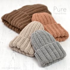 four knitted beanies are lined up on a white surface with the text, pure hand knits