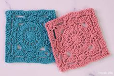 two crocheted squares sitting on top of a table