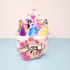 a birthday cake with princess figurines on top