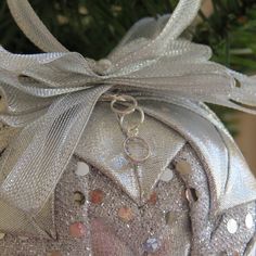 a christmas ornament with silver ribbon around it