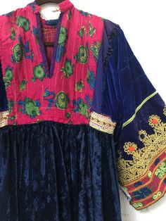 "A gorgeous, traditional Afghani Kutchi dress made by hand. Me asurements are 20\" across the chest. 48\" from mid shoulder to the bottom of the piece. 19 1/2\" long from shoulder to wrist." Transitional Multicolor Embroidered Dresses, Transitional Season Embroidered Multicolor Dresses, Folk Style Embroidered Transitional Dresses, Folk Style Ceremonial Dress With Embroidered Border, Ceremonial Folk Dress With Embroidered Border, Fitted Bohemian Embroidered Dress For Traditional Ceremonies, Traditional Dress With Embroidered Neckline For Festivals, Ceremonial Folk Style Embroidered Dresses, Ceremonial Bohemian Embroidered Fitted Dress