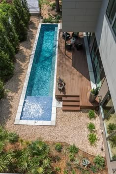 an aerial view of a swimming pool and deck in a home's back yard