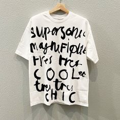 a white t - shirt with black writing on it that says, supreme magnificently frys fire cool and chic