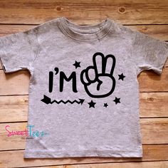 "\"I'm 2\" birthday tee. So cute and funny for your little one's second birthday, for regular wear or perfect as a gift. For a 3rd birthday tee: https://www.etsy.com/listing/546602427/birthday-shirt-im-3-shirt-third-birthday?ref=shop_home_active_1 ➜➜ To upgrade to LONG sleeves: https://www.etsy.com/listing/538047040/upgrade-to-long-sleeve-for-a-black-or?ga_search_query=upgrade&ref=shop_items_search_1 Please choose your shirt color by reviewing our color chart in the 2nd photo of this listing Fun Graphic Print T-shirt For First Birthday, Cute Birthday T-shirt With Funny Text, Playful Crew Neck Top For First Birthday, Playful Letter Print Tops For Birthday, Playful Cartoon Print Tops For First Birthday, Playful Tops With Cartoon Print For First Birthday, Fun Cartoon Print Tops For First Birthday, Cute Cotton T-shirt For Birthday, Cute Birthday T-shirt, Pre-shrunk