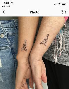 two people with matching tattoos on their arms