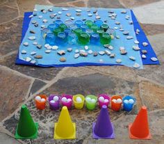 an outdoor game set up on the ground with cups and cones in front of it