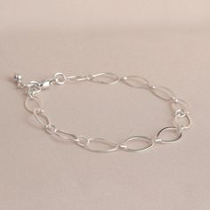 "* Sterling Silver Long Loop Layering Bracelet * * Beautiful sterling silver long loop layering bracelet finished with a sterling silver lobster claw clasp and completed with sterling silver bead. This bracelet 7\" long and is created with 925 sterling silver material and not made with plated materials. * Heart Clay Dish (also sold separately) https://www.etsy.com/listing/1094093610/heart-ring-dish-boho-ring-dish-christmas * This bracelet will arrive in a box tied with a ribbon perfect for gift Adjustable Oval Link Sterling Silver Bracelet As Gift, Everyday Simple Silver Bracelets, Nickel-free Link Chain Bracelet Minimalist Style, Silver Sterling Minimalist Paperclip Bracelet, Elegant Silver Chain Paperclip Bracelet As Gift, Simple Sterling Silver Chain Bracelet For Everyday, Sterling Silver Minimalist Paperclip Bracelet Gift, Nickel Free Sterling Silver Link Bracelet, Everyday Simple Sterling Silver Chain Bracelet