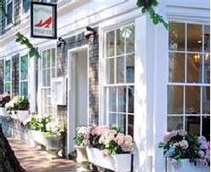 a row of windows with flower boxes on the outside