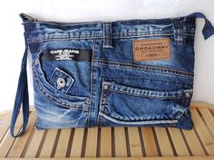 a blue jean purse sitting on top of a wooden table