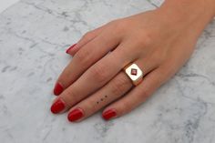 "This is an impressive 14k gold and garnet signet ring. It is made of 14k//18k gold (per your choice), and there is a red garnet set in its center, in a beautiful rhombus inlay, to add to its luxurious, unique style. Get this elegant gold square signet ring for your loved one, or yourself, to upgrade every outfit you own with a meaningful, timeless, shiny and impressive piece of jewelry. ✿ Item details ✿ ✿ Materials: - 14k/18k Yellow//Rose//White Gold (per your choice) - A red garnet of 0.50CT; Luxury Red Heirloom Signet Ring, Modern 14k Gold Red Rings, Gold Ruby Signet Ring With Polished Finish, Modern Gold Ruby Ring, Heirloom Red Gold Signet Ring, Yellow Gold Garnet Signet Ring With Gemstone, 14k Gold Red Signet Ring For Anniversary, Classic 14k Gold Red Signet Ring, Classic Red 14k Gold Signet Ring