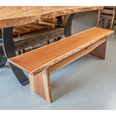 a wooden bench sitting in front of a table with metal legs and wood planks