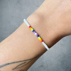 Simple pride bracelet  To order: For a snug fit, order your exact size.  For a looser fit, order one or two sizes up. White Hypoallergenic Friendship Bracelets For Everyday, Rainbow Casual Bracelets For Everyday, White Wristband For Everyday Use, White Round Beaded Wristband For Friendship, Casual White Bracelets For Friendship, Everyday White Beaded Wristband, Casual White Round Bead Wristband, Casual White Round Beads Wristband, Casual White Bracelets For Everyday Wear