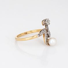 Finely detailed antique Edwardian diamond & pearl ''moi et toi'' ring crafted in 18k yellow gold (circa 1910s).    The old cushion cut diamond is estimated at 0.25 carats, accented with a further 23 estimated 0.01 carat rose cut diamonds. The total diamond weight is estimated at 0.48 carats (estimated at J-K colour and I1-2 clarity). The pearl measures 5.3mm.   The distinct and stylish ring is a great example of Edwardian era jewellery. The two stone diamond & pearl ''Moi et Toi'' design is a Fr Victorian Style 14k Yellow Gold Pearl Ring, Victorian 14k Yellow Gold Pearl Ring, Heirloom 14k Gold Pearl Ring With Rose Cut Diamonds, Antique Yellow Gold 14k Pearl Ring, Antique Pearl Ring For Wedding, Antique Yellow Gold Pearl Ring With Rose Cut Diamonds, Antique 14k Stamped Pearl Wedding Ring, Antique 14k Stamped Pearl Ring For Wedding, Classic Yellow Gold Pearl Ring With Diamond