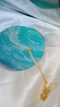 a blue plate with a gold chain attached to it