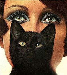 a woman with blue eyes and black cat's head in front of her face