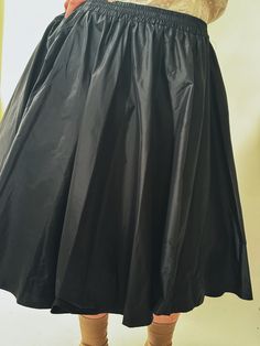 A classic flared skirt reimagined, the Bira Silk Taffeta Skirt has opulent organic gathers, creating movement and soft drama. Elastic waist for comfort, flared silhouette, cut in luminous silk taffeta. Wear with our Neruda Blouse, or your favourite black tee, or with our Frou Crinoline Skirt for added volume. Made in New York's Garment District by a small team of dedicated seamstresses. Ships in 10 business days. Evening A-line Skirt With Pleated Waist, Silk A-line Flowy Skirt, Silk A-line Evening Skirt, Cocktail A-line Skirt With Pleated Waist, Elegant Stretch Pleated Tiered Skirt, Stretch Pleated Full Skirt Petticoat, Stretch Full Petticoat With Pleated Skirt, Black Pleated Silk Skirt, Spring Satin Skirt With Gathered Detail