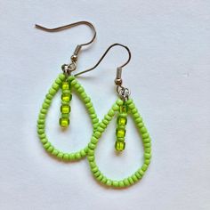 These handmade, beaded teardrop earrings come in a variety of colors. This pair is a light green color. Perfect for all occasions and super comfortable to wear. These earrings are not heavy at all and can be worn comfortably all day. The earrings are 2 cm across. Every pair is unique and  may look somewhat different than the picture. I love making these earrings and hope you enjoy wearing them! Trendy Teardrop Beaded Earrings With Ear Wire, Trendy Handmade Adjustable Teardrop Earrings, Trendy Green Beaded Drop Earrings, Trendy Teardrop Earrings With Dangling Beads, Hypoallergenic Teardrop Beaded Earrings For Jewelry Making, Trendy Green Beaded Dangle Earrings, Trendy Teardrop Beaded Earrings As Gift, Trendy Teardrop Beaded Earrings With Dangling Beads, Trendy Green Earrings With Colorful Beads