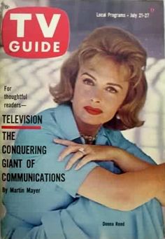 a magazine cover with a woman in blue shirt and tie on the front, looking to her left