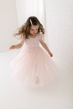 The Perfect Sienna Flower Girl Dress with very soft blush pink lace on the neckline and floor-length tulle skirt adds extra elegance to the dress. Princess Style Lace Dress For Dress-up, Princess Dress With Lace Bodice And Tulle For Dress-up, Tulle Dress With Lace Trim For Dress-up, Fitted Lace Dress With Lace Sleeves For Dress-up, Princess Style Bridesmaid Dress With Lace Trim, Princess Style Dress With Lace Bodice And Tulle, Wedding Tutu Dress With Lace Bodice, Pink Dress With Lace Bodice, Short Sleeve Tulle Dress With Lace Trim