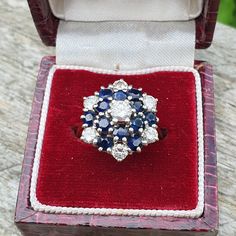 A stunning vintage 18ct gold ring adorned with numerous sapphires and diamonds in a floral design. The seven diamonds have a total approximate weight of 0.5 cts. There are hallmarks on the inner shank with a London stamp and date letter "B" for 1976. The total ring weight is 5.70 g. Please message with any other queries and I can provide additional photos if required. Please check out the other items in my shop. Be sure to view all photos and videos for condition and read the titles and descript Vintage Sapphire Gemstone Diamond Ring, Hallmarked Cluster Sapphire Ring For Wedding, Vintage Cluster Sapphire Wedding Ring, Vintage Blue Cluster Ring For Formal Occasions, Vintage Cluster Sapphire Ring For Wedding, Vintage Flower Ring With Brilliant Cut For Formal Occasions, Gift Cluster Sapphire Ring, Vintage Brilliant Cut Flower Ring For Formal Occasions, Vintage Hallmarked Flower Ring For Formal Occasions