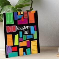 a monster's inc book sitting on top of a table next to a potted plant