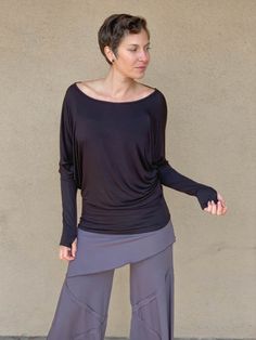 caraucci women's plant-based lightweight loose fit dolman long sleeve rayon jersey black top with thumbholes #color_black Jersey Tops, Dolman Sleeve Tops, Extra Long Sleeves, Loose Fitting Tops, Long Sleeve Jersey, Jersey Top, Dolman Sleeve, Small Batches, Long Sleeve Top