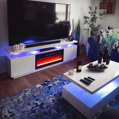 a living room with a couch, coffee table and television on it's stand