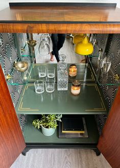 a shelf with glasses and candles on it