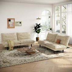 a living room with two couches and a coffee table in front of a large window