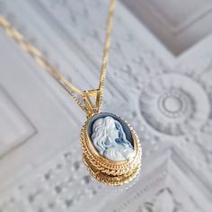 Introducing the Annie Mae necklace! Suitable for one who is truly wild and free at heart.  Featuring a blue agate cameo necklace framed with a golden silver sterling 925 textured frame and chain. Total necklace length: 44cm Cameo pendent: 1 X 1.5 cm AVAILABLE ALSO IN SILVER! Check out our Cameo Necklaces section! Design: a lady with long loose hair, gazing romantically. Shape: Oval. Agate is a variety of banded Chalcedony, which is a variety of the mineral Quartz, known for helping you express y Cameo Medallion Jewelry For Gifts, Cameo Medallion Jewelry Gift, Wedding Cabochon Medallion Necklace, Wedding Necklaces With Cameo Round Pendant, Blue Cameo Jewelry For Wedding, Elegant Oval Cameo Locket Necklace, Blue Cameo Necklace For Wedding, Blue Cameo Jewelry Gift, Elegant Cameo Locket Necklace For Wedding