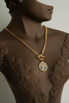 Elevate your style with our Exquisite 22k Gold-Plated Tree of Life Necklace, a perfect blend of elegance and symbolism. This stunning piece features a meticulously crafted Tree of Life pendant, symbolizing growth, strength, and interconnectedness. The necklace is plated in 22k gold, providing a luxurious and radiant finish. The Tree of Life pendant hangs gracefully from a sturdy yet elegant gold chain, secured with a stylish toggle clasp, ensuring both beauty and durability. Ideal for any occasi The Tree Of Life, Tree Of Life Necklace, Tree Of Life Pendant, Pendant Design, Gold Plated Necklace, Toggle Clasp, 22k Gold, Chain Styles, Tree Of Life