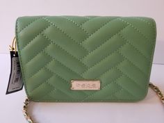 This elegant new with tag Bebe Sophia crossbody handbag is perfect for any occasion. The rectangular shape and quilted accents add a touch of sophistication, while the green exterior color and gold hardware provide a pop of style. The magnetic closure keeps your belongings secure,  giving it a sleek look. With a size of 7.5" by 4" by 2", this small bag is perfect for travel, weddings, parties, and even everyday use. The faux leather fabrication ensures durability for every day use. The bebe Sophia handbag is a must-have for any fashion-forward woman, making it a great addition to your collection. ***Please review pictures.*** Thank you for shopping with us! Green Quilted Crossbody Shoulder Bag, Chic Green Quilted Bag, Trendy Green Quilted Shoulder Bag, Chic Quilted Green Bags, Green Exterior, Handbag Straps, Small Crossbody, Wow Products, Small Bag