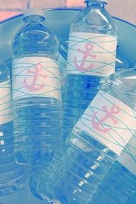 four water bottles with labels on them sitting in a blue bucket next to each other