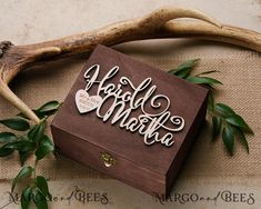 a wooden box sitting on top of a table next to antlers