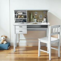 a white desk with a chair next to it and a teddy bear on the floor