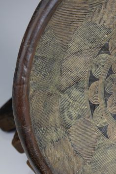 an old wooden bowl with intricate designs on it