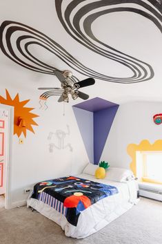 a child's bedroom decorated in black and white with colorful art on the walls