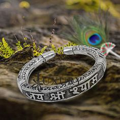 92.5% pure silver handmade excellent unisex bangle bracelet kada, amazing Divine lord Krishna "JAI SHRI SHYAMA" Mantra kada, best customized chitai work unisex personalized gift from India, Metal-925 sterling silver. Item type-Bangle bracelet. Weight-42.420 grams width-1.0 cm size-2-6 to 2-10 or (easily wear by twisting both faces of kada) stamped-925 Finish-oxidized. makes excellent gifting for birthdays, mother's day, wedding anniversaries, valentines day, Christmas day Silver Bracelets For Navratri, Oxidized Bangle For Festivals, Sterling Silver Bangle For Ceremonial Festivals, Silver Openable Bangle For Festivals, Sterling Silver Bangle For Rituals And Festivals, Sterling Silver Oxidized Cuff Bracelet For Festivals, Festivals Sterling Silver Cuff Bracelet With Oxidized Finish, Festival Oxidized Sterling Silver Cuff Bracelet, Ceremonial Silver Openable Bangle