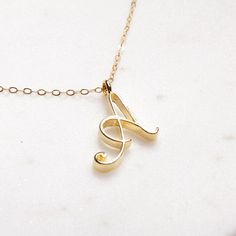 A Initial Necklace - Timeless cursive "A" initial gold pendant - Personalized, Monogram jewelry for women - Vintage inspired font. Delicate "A" initial. Perfect every day necklace. Lovely gift for your self, sister, bridesmaids, new mom. Pendant: Base metal is brass and 14K gold plated. Chain is 18 inches, 14k gold filled. Note: model shots might show a different initial, only to illustrate overall look and length of the chain. This listing is for the "A" initial. Luxury Elegant Name Necklace With Initial Pendant, Luxury Initial Necklace As Gift, Luxury Initials Necklace As A Gift, Cheap Elegant Initial Necklace, Luxury Timeless Necklace With Initial Pendant, Elegant Cheap Initial Necklace For Birthdays, Elegant Initial Pendant Charm Necklace, Cheap Initial Pendant Necklaces For Birthday Gift, Luxury Modern Initial Necklace For Gifting