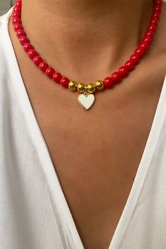 The heart at the end is gold plated and the white part is created with enamel, the beads used are glass.  The length of the necklace is 15,7 inch. Elegant Gold Beaded Necklaces For Valentine's Day, Gold Beaded Necklaces With Heart Charm And Round Beads, Elegant Heart-shaped Jewelry With Gold Beads, Heart Beaded Necklaces As Gifts, Elegant Heart-shaped Jewelry With Colorful Beads, Elegant Heart-shaped Colorful Beads Jewelry, Elegant Heart-shaped Colorful Beaded Jewelry, Elegant Beaded Necklaces With Heart Charm As Gift, Gold Heart Jewelry With Colorful Beads