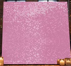 pink sequin backdrop with candles in the background