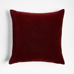 a dark red pillow on a white background